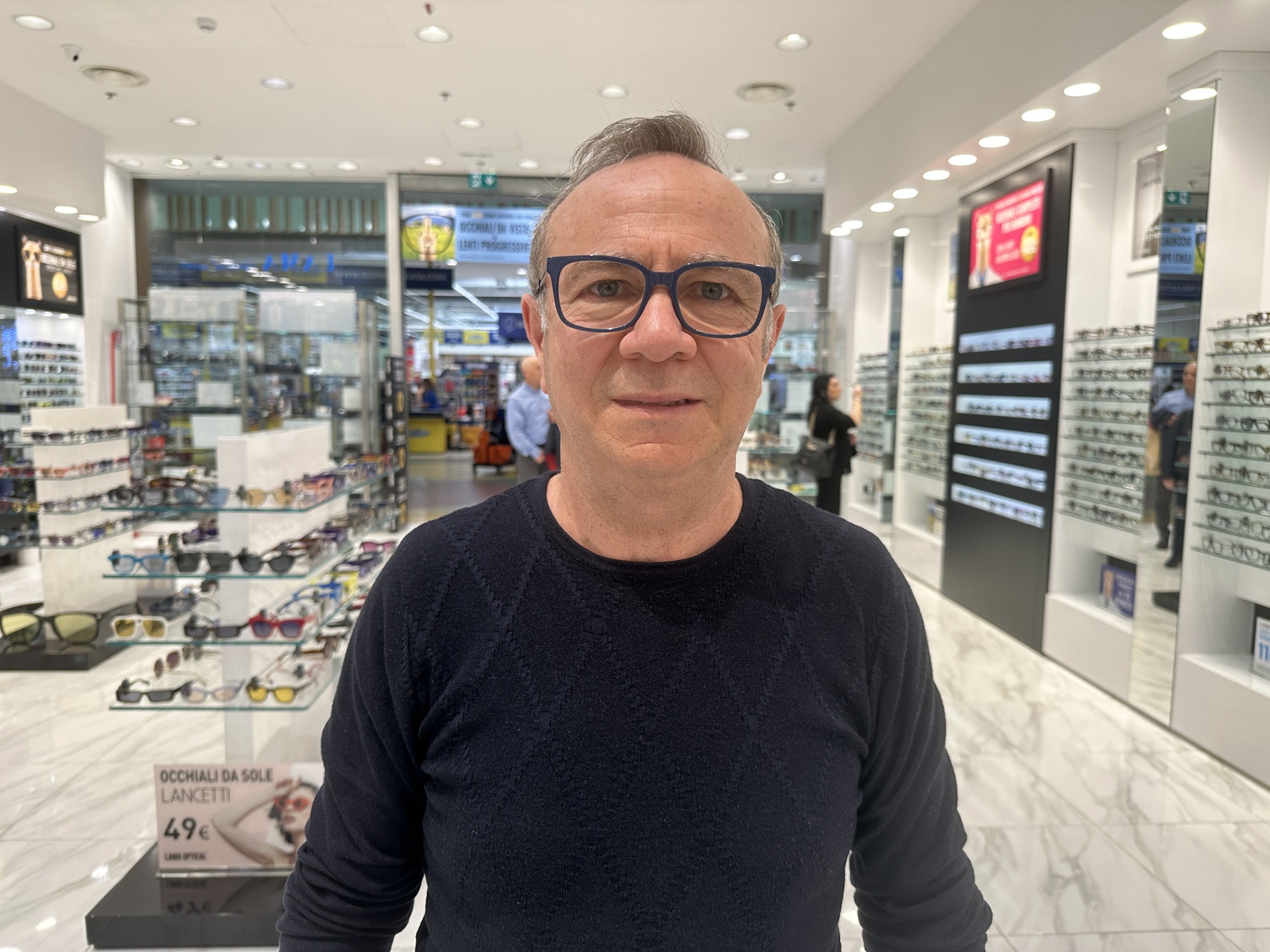 Croce standing inside an Italian optical shop after getting new progressive glasses