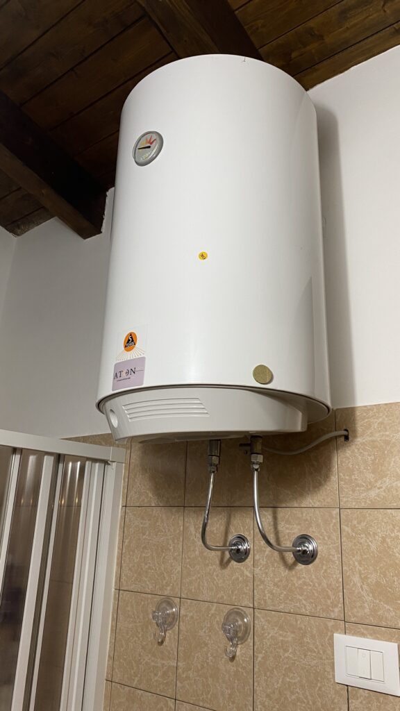 Wall-mounted electric water heater in a Sicilian home showing real cost of living in Sicily Italy