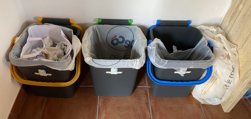 Garbage bins outside a rural Sicilian cottage