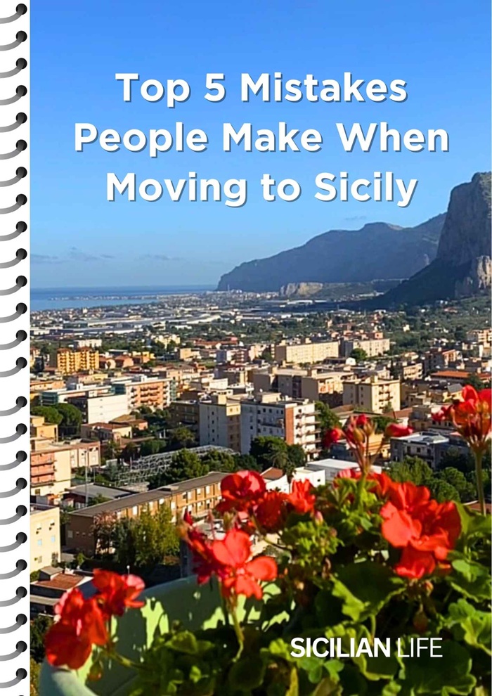 Cover of Sicilian Life guide with a view of Carini, Sicily and red flowers in the foreground